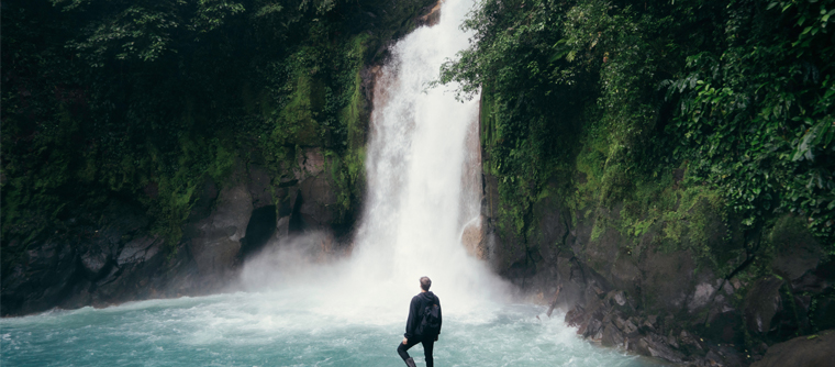 Hiker looking at waterfall